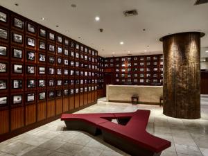 a library with a red bench in the middle at Royal Pines Hotel Yonezawa in Yonezawa +70 photos