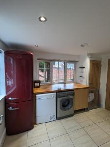 a kitchen with a red refrigerator and a dishwasher at The Stables - Private room in a shared house in Hartford +21 photos