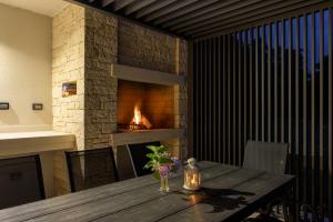 a wooden table with a fireplace in a room at Villa Apolonia by IstriaLux in Pazin