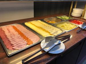 a buffet with different types of meats and cheese at East City Budapest in Budapest +34 photos