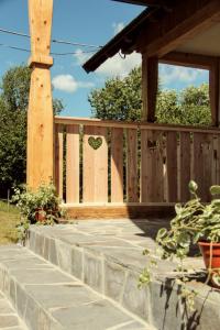 a wooden fence with a heart cut into it at La Ferma Nagy in Vişeu de Sus