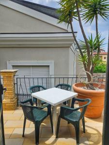 a white table and four chairs on a balcony at Domus Rossetti in Vasto +40 photos