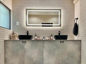 a bathroom with two sinks and a mirror at 森の街34# Nature Escape BBQ in Wada