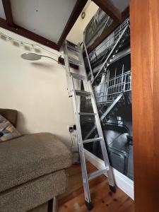 a ladder in a room with a bunk bed at Two Top Central Unique Artisan Beach Studios - also separate spa cabin in Brighton & Hove
