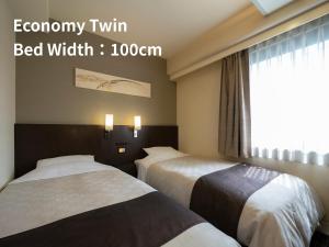 Postel nebo postele na pokoji v ubytování Hotel Binario Umeda