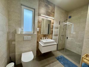 a bathroom with a sink and a toilet and a shower at Emma Casa Apartmant FREE Private Parking with EV supply availability in Budapest +2 photos