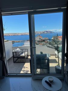 a room with a view of the ocean through a window at Perla in Stinica +4 photos