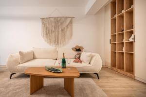 a living room with a white couch and a table at Lotti in Infinity Pool & Spa Resort in Mamaia +56 photos