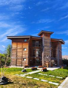 a large wooden house with a yard at Shackleton Chalet in Sestriere