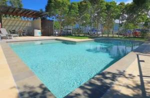 a large swimming pool with blue water at Beachside Escape 200m From Ocean in Casuarina