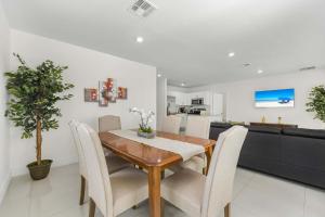 a dining room with a wooden table and chairs at Modern 4BR Retreat with Private Pool - Near Brickell in Miami