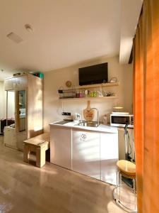 a kitchen with a sink and a microwave at Mountain View Apartment Near Ski Slopes Gudauri in Kʼumlistsʼikhe