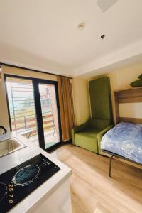 a room with a bed and a kitchen with a sink at Mountain View Apartment Near Ski Slopes Gudauri in Kʼumlistsʼikhe