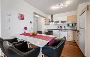 a kitchen with a dining room table and chairs at Ferienwohnung Pörtschach 90M² in Pörtschach am Wörthersee