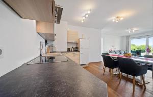 a kitchen with a black counter top and a table at Ferienwohnung Pörtschach 90M² in Pörtschach am Wörthersee