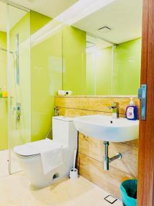 a bathroom with a sink and a toilet and a mirror at Vortex Suites KLCC by Nadia in Kuala Lumpur +7 photos