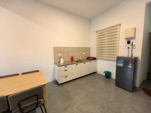 a kitchen with a sink and a refrigerator in a room at Simfoni Comfy Premium 12 in Langkawi Islands