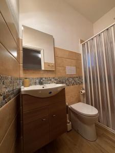 a bathroom with a toilet and a sink and a mirror at La Dimora Sicula in Modica +43 photos