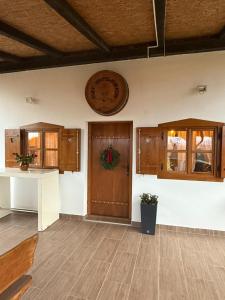 a living room with a wooden door and a table at Villa S&S 