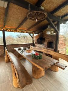 a wooden table and bench in a room with a fireplace at Villa S&S 