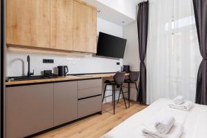 Una cocina con gabinetes blancos y encimera. en Marvie Apartments, en Rijeka