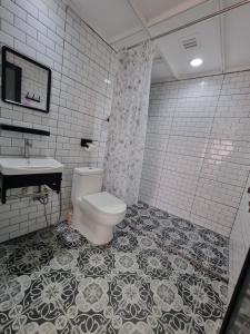 a bathroom with a toilet and a sink at Sunset Seaview Apartment A73 in Port Dickson +11 photos
