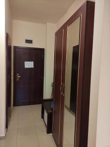 a corridor with a door and a mirror in a room at Beachfront apartment in 4star Hotel - Kiten in Kiten +2 photos