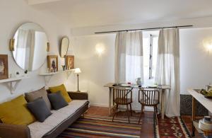 a living room with a couch and a table at Chambres Avec Vue in Sète