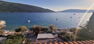 a view of a lake with people swimming in the water at Sea Side in Herceg-Novi