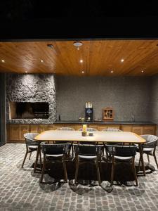 two tables and chairs in a room with a stone wall at Garden Hill Mitrovac na Tari in Mitrovac +79 photos