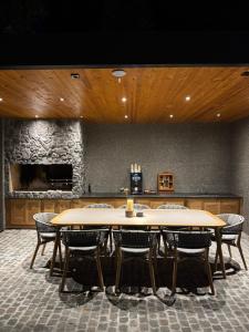 a table and chairs in a room with a stone wall at Garden Hill Mitrovac na Tari in Mitrovac