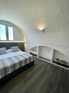 a bedroom with a bed in a white room at Calliope in Gallipoli