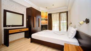 a bedroom with a large bed and a mirror at Agathoupoli beach in Órmos Methónis