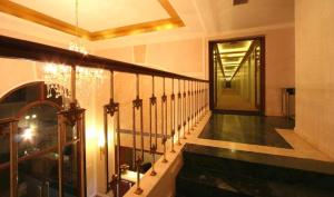 a staircase in a building with a chandelier at Hotel Le castle in Jāmb