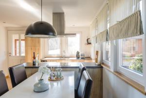 a kitchen with a table and a black pendant light at Cormanns Hüttchen in Schmallenberg