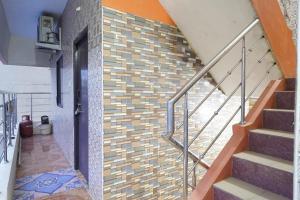a staircase in a house with a brick wall at Royal Park in Vellore
