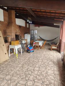 a living room with a table and a motorcycle in it at Casa grande com piscina in Itanhaém +2 photos