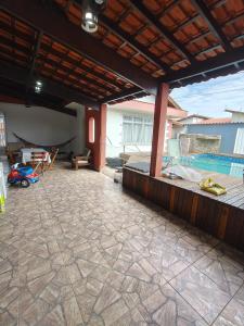 a patio with a swimming pool in a house at Casa grande com piscina in Itanhaém
