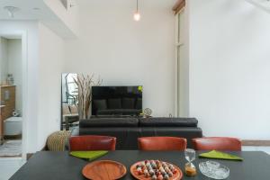 a living room with a black table and a couch at Oasis 2 Masdar City in Abu Dhabi