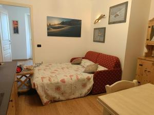 a room with a bed and a couch and a table at Natali Home by Holiday World in Ponte di Legno
