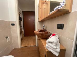 a bathroom with a wooden sink and a mirror at Natali Home by Holiday World in Ponte di Legno