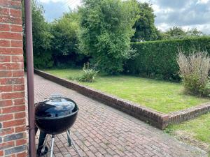 a bbq grill sitting on a brick driveway at Swallows Retreat in Fordingbridge +15 photos