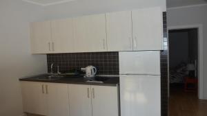 a kitchen with white cabinets and a white refrigerator at Apt. El Molino 3A in Valle Gran Rey