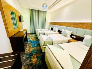 a hotel room with three beds at فندق ديار العروبة Diyar Al Arouba Hotel in Jarwal +14 photos