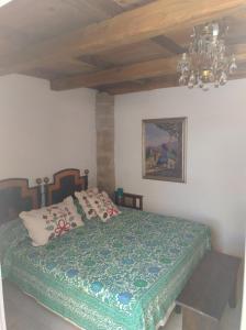 a bedroom with a bed and a chandelier at La Coloniale San Pantaleo in San Pantaleo