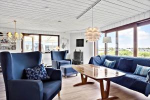 a living room with blue couches and a table at 325-Thisted-Sotungevej-35 in Thisted