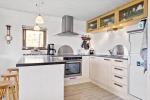 a kitchen with white cabinets and a black counter top at 325-Thisted-Sotungevej-35 in Thisted +11 photos