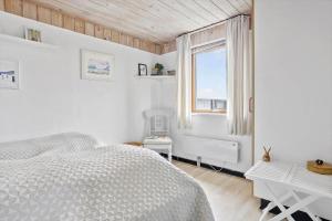 a white bedroom with a bed and a window at 325-Thisted-Sotungevej-35 in Thisted