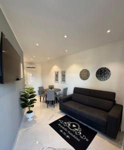 a living room with a couch and a table at Mondello Sunshine Apartment in Mondello +18 photos