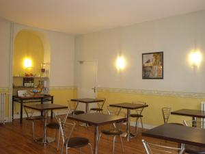 a classroom with tables and chairs in a room at Fasthotel Pau-Centre HOTEL ADOUR in Pau